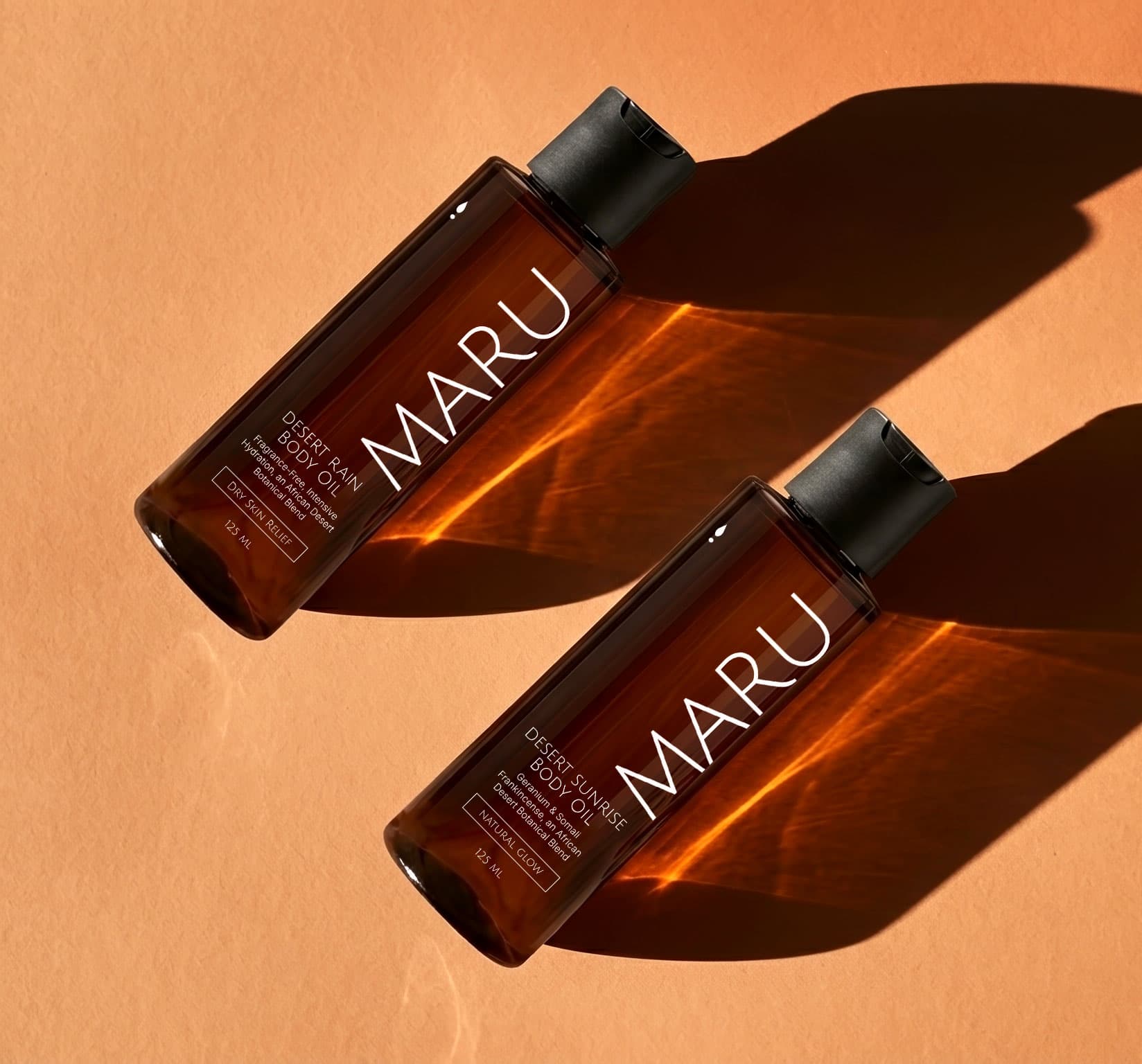 Maru body oil bottle on a soft background, designed for melanin-rich skin