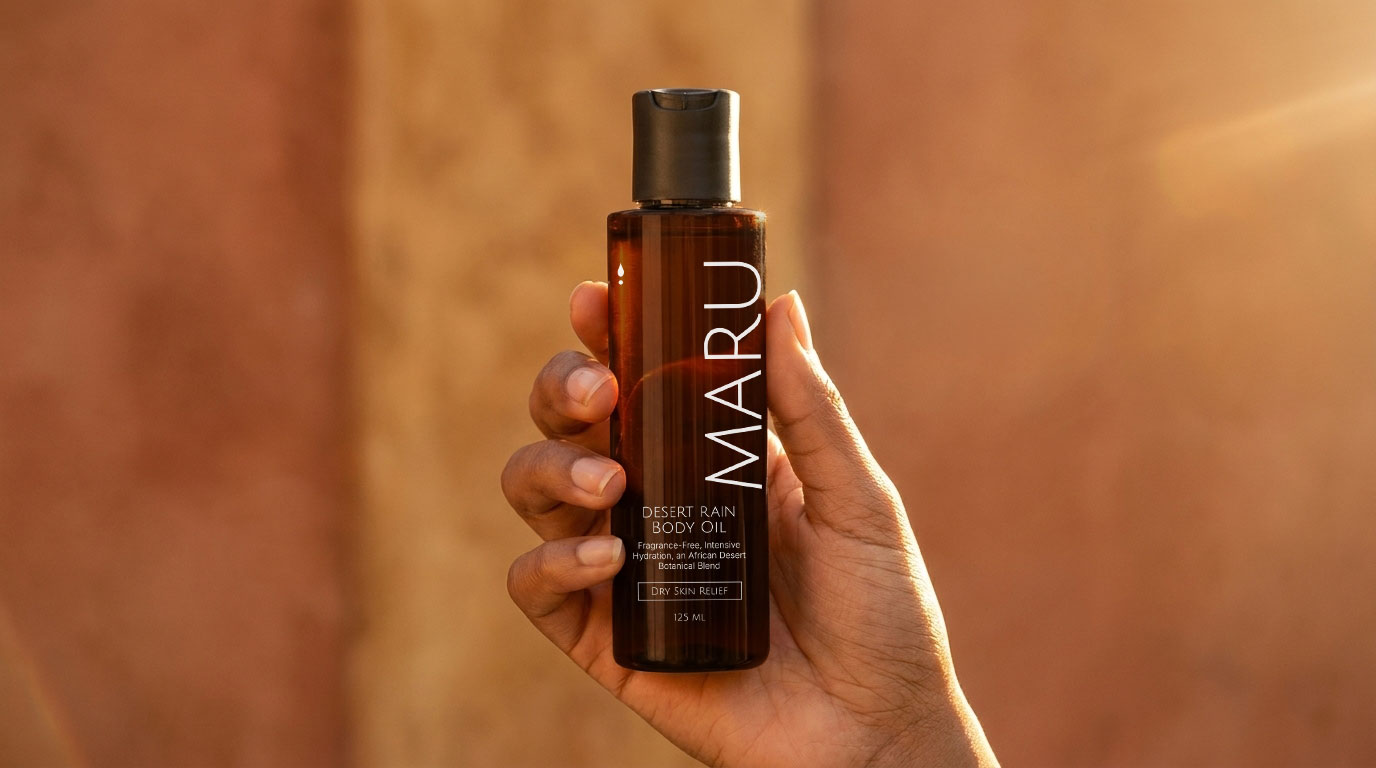 Maru body oil bottle held in hand